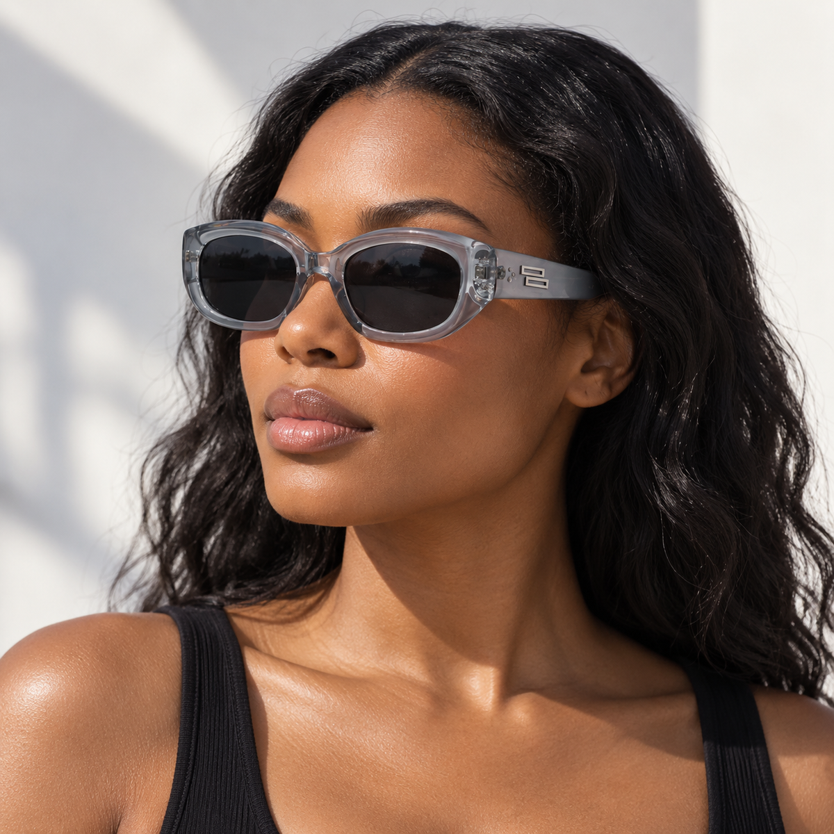 Adult model wearing Nashi Pear 988 Oval Sunglasses in a clear gray frame with gray lenses