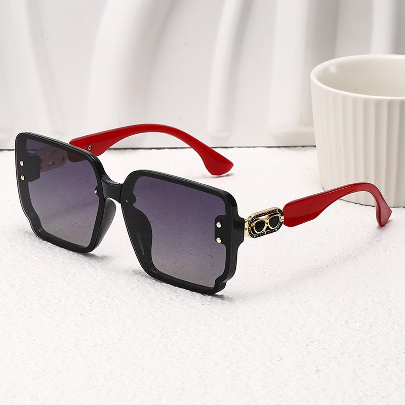 Nashi Pear T41 oversized square sunglasses, glossy black frame with red temples and dark lenses, single pair